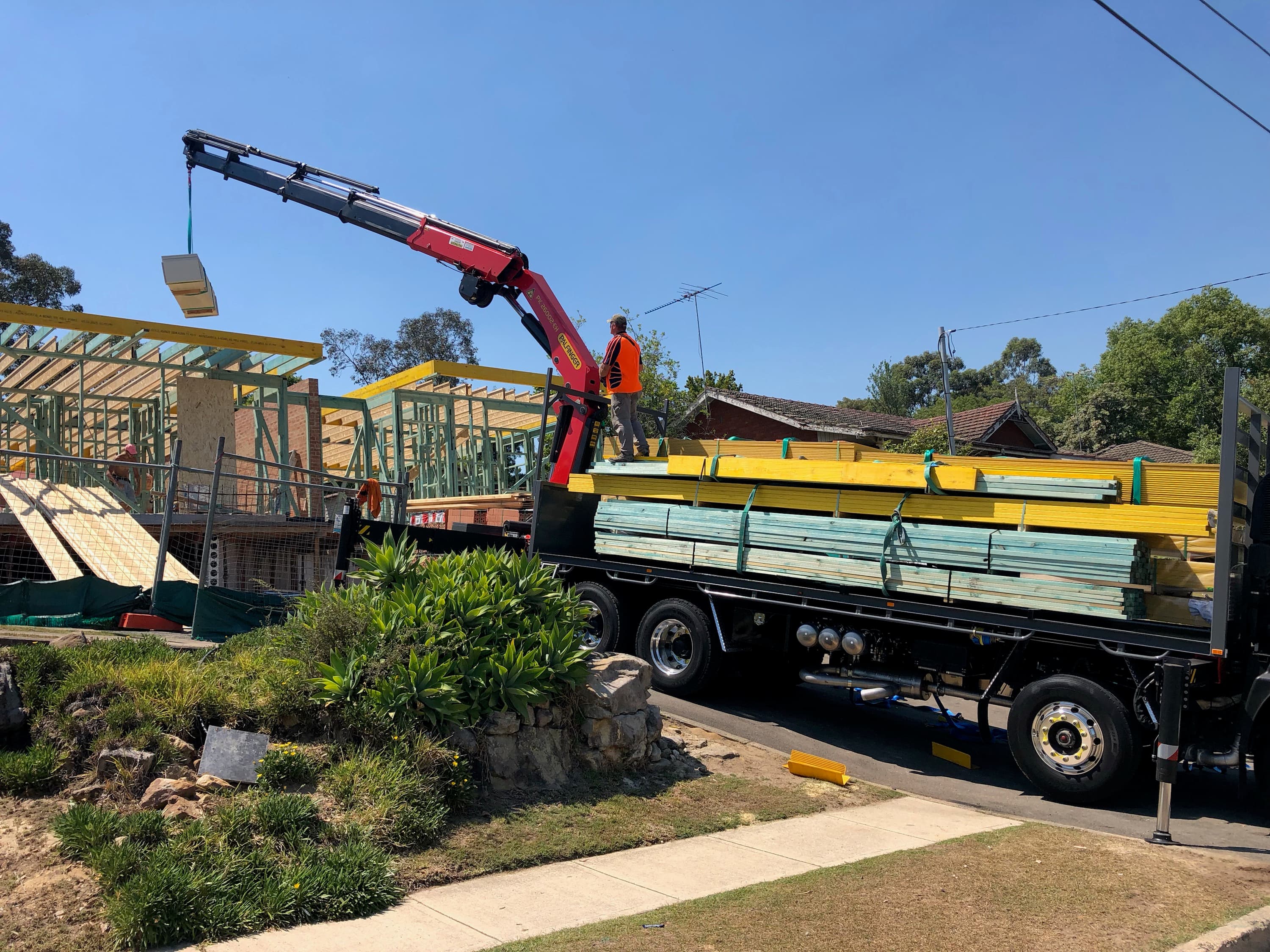 Onsite Timber crane truck delivering framing on site