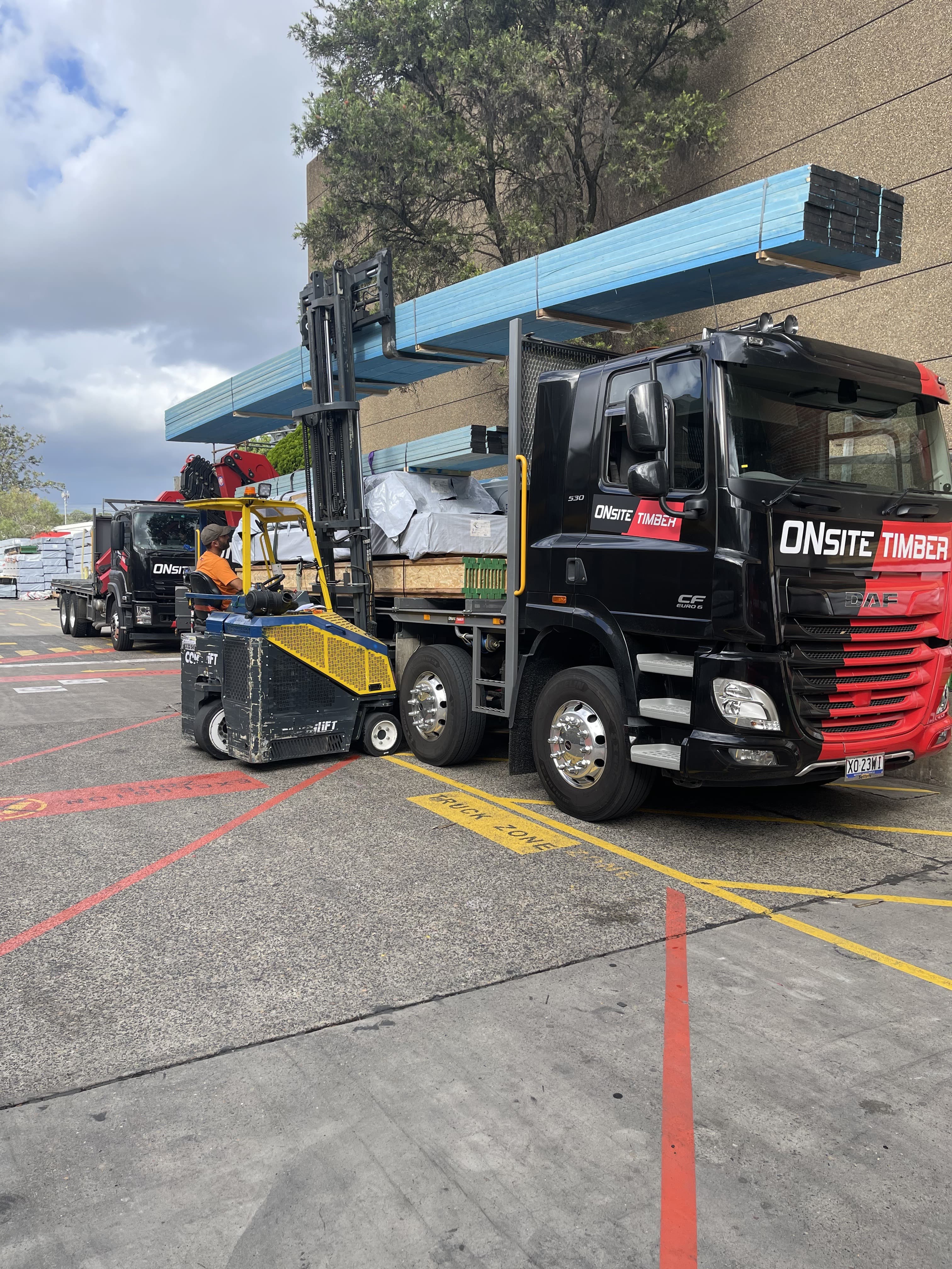 Forklift loading oversized E10 timber onto an Onsite Timber truck